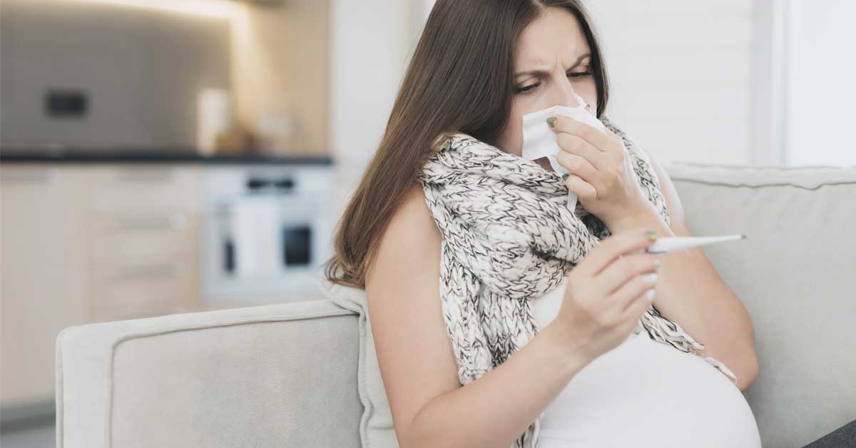Pregnant woman experiencing fever and cold symptoms.